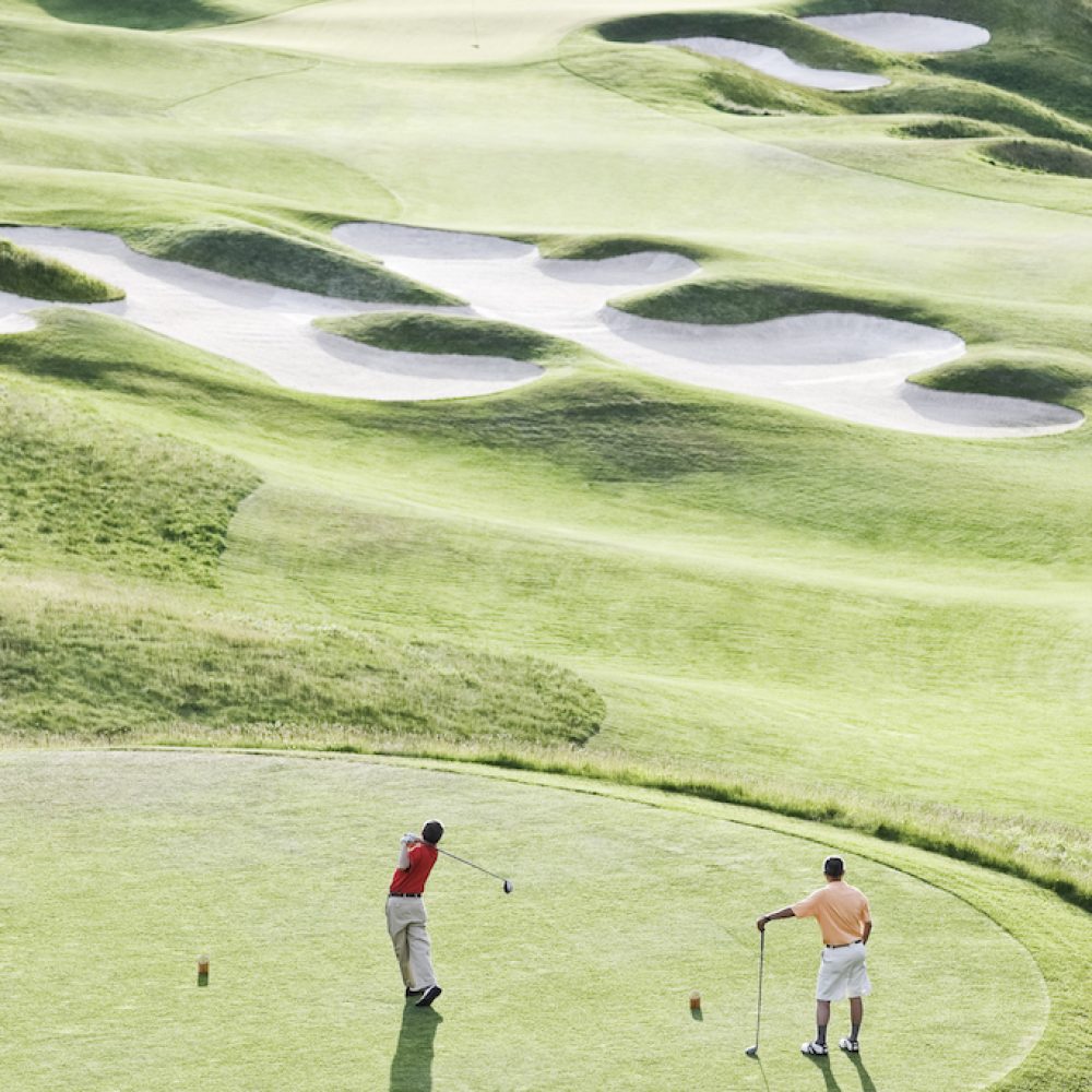 view-from-above-of-two-golfer-teeing-off-on-a-golf-2022-03-04-02-14-26-utc.jpg